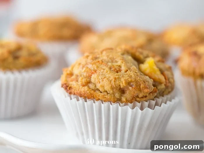 Freshly baked peach ginger paleo muffins showcasing a tender crumb and juicy peach pieces.