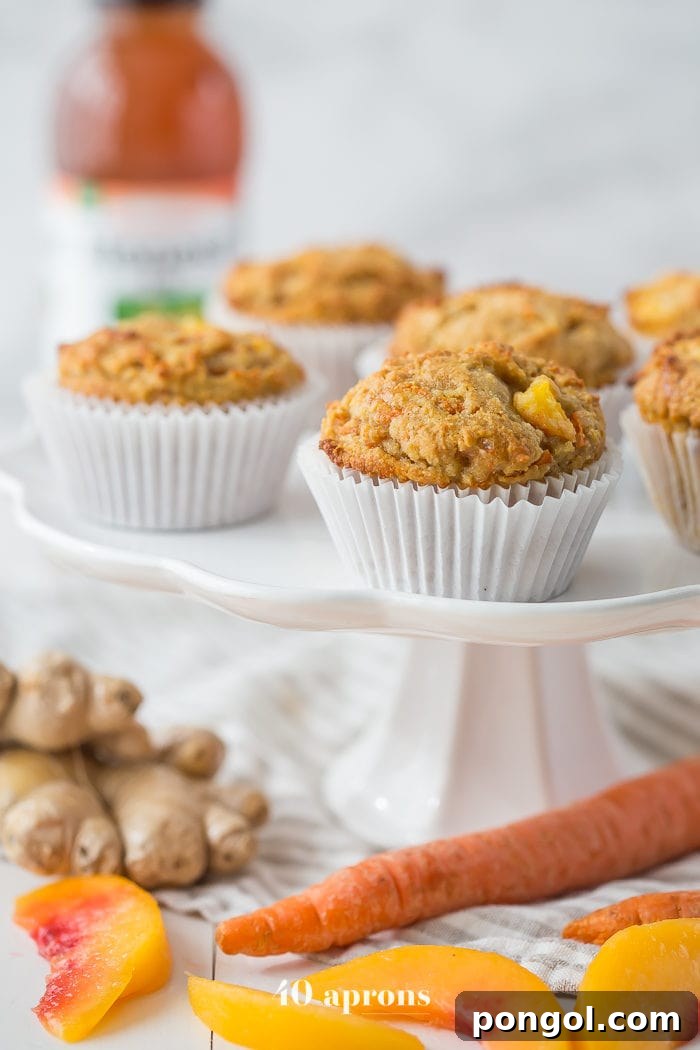 A stack of golden-brown peach ginger paleo muffins, ready to be enjoyed.