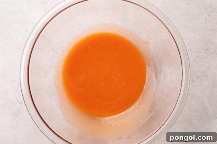 Golden Chicken Bites 8 Homemade buffalo sauce in a large glass mixing bowl.