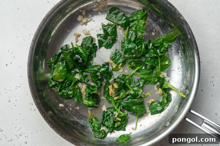 Shallots, garlic, butter, and wilted spinach in a large skillet.