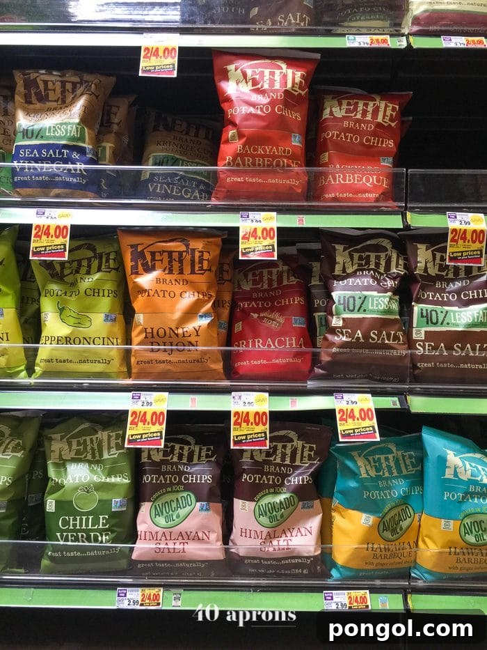 Assorted Kettle Brand Avocado Oil Potato Chip bags on a grocery store shelf.
