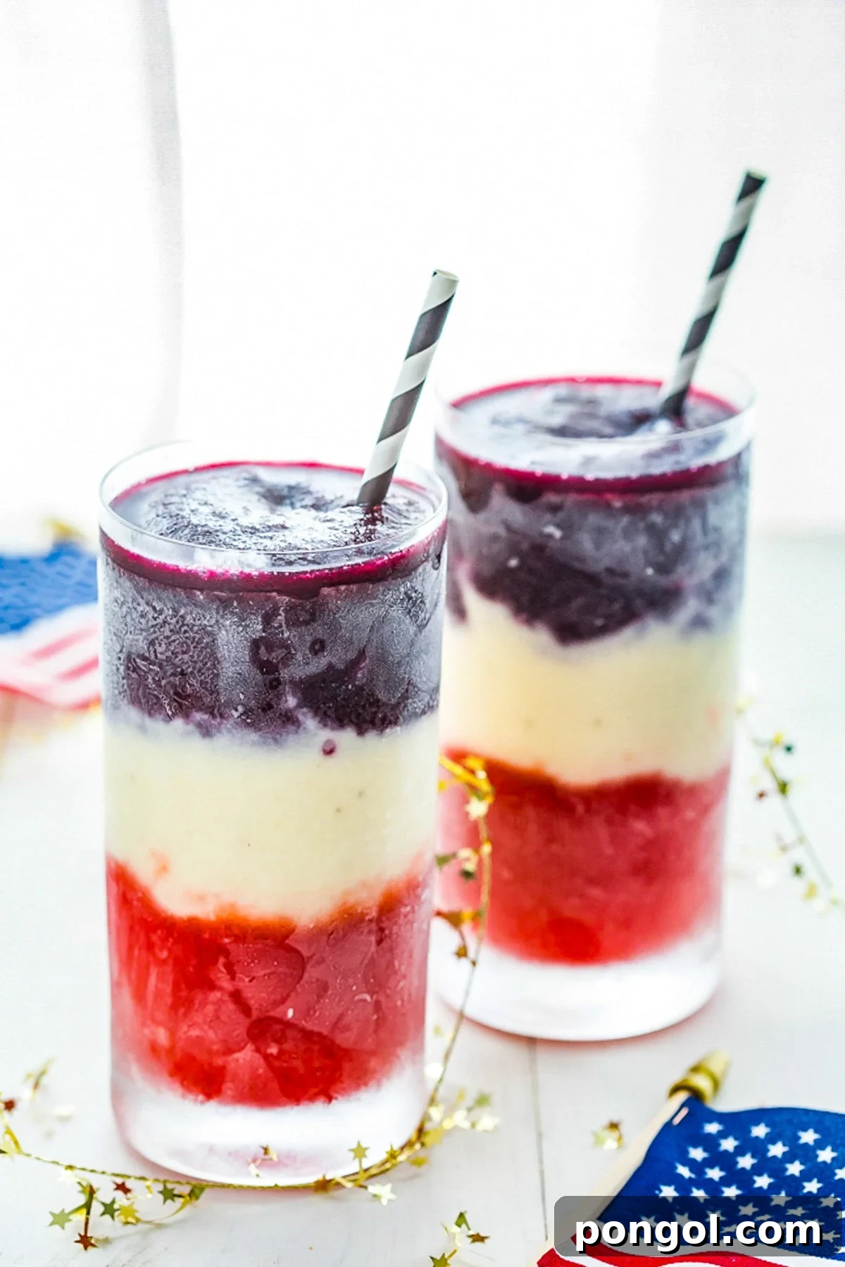 A side-by-side view of two paleo red, white, and blue cocktails, highlighting their vibrant colors and festive presentation.