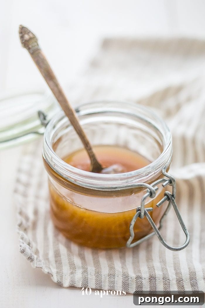 Close-up of creamy Paleo Vegan Caramel Sauce drizzled elegantly over a dessert