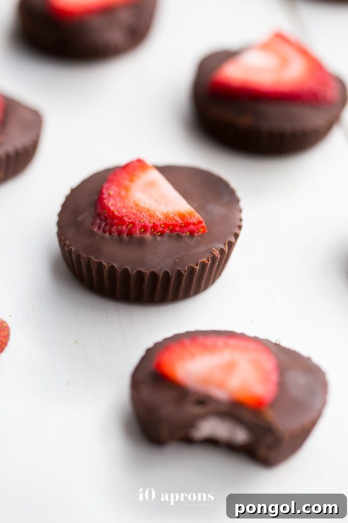 Array of Strawberry Coconut Butter Cups, garnished with fresh strawberry slices