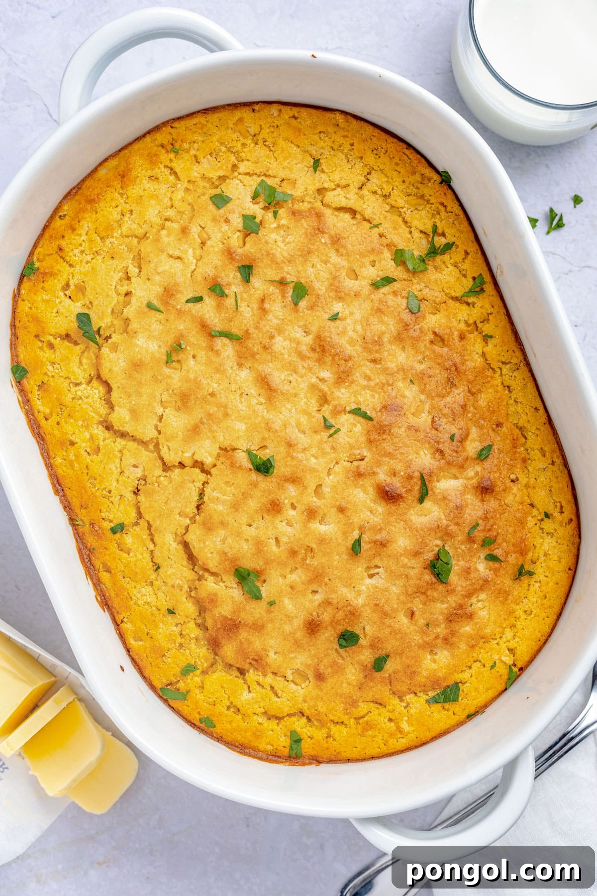30 Festive Casseroles Your Holiday Table Needs 23 Overhead view of a large oval casserole dish holding a cornbread casserole.