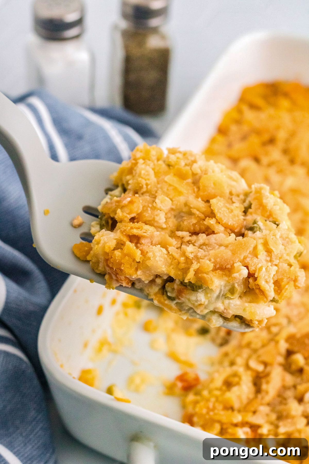 30 Festive Casseroles Your Holiday Table Needs 31 A spatula lifting a serving of veg-all casserole out of a rectangular casserole dish.