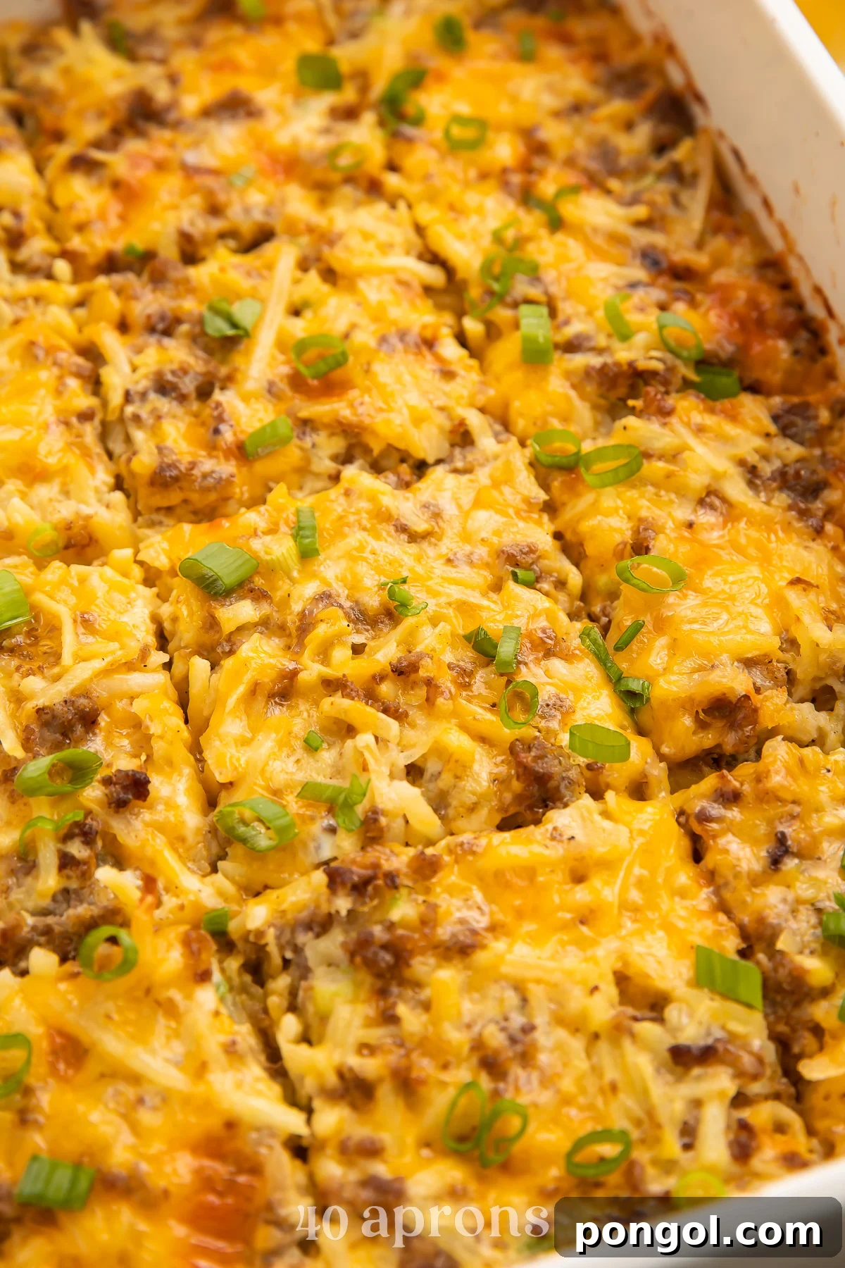 30 Festive Casseroles Your Holiday Table Needs 9 Angled photo of a rectangular white casserole dish with a fully-baked gluten free breakfast casserole cut into 12 squares.