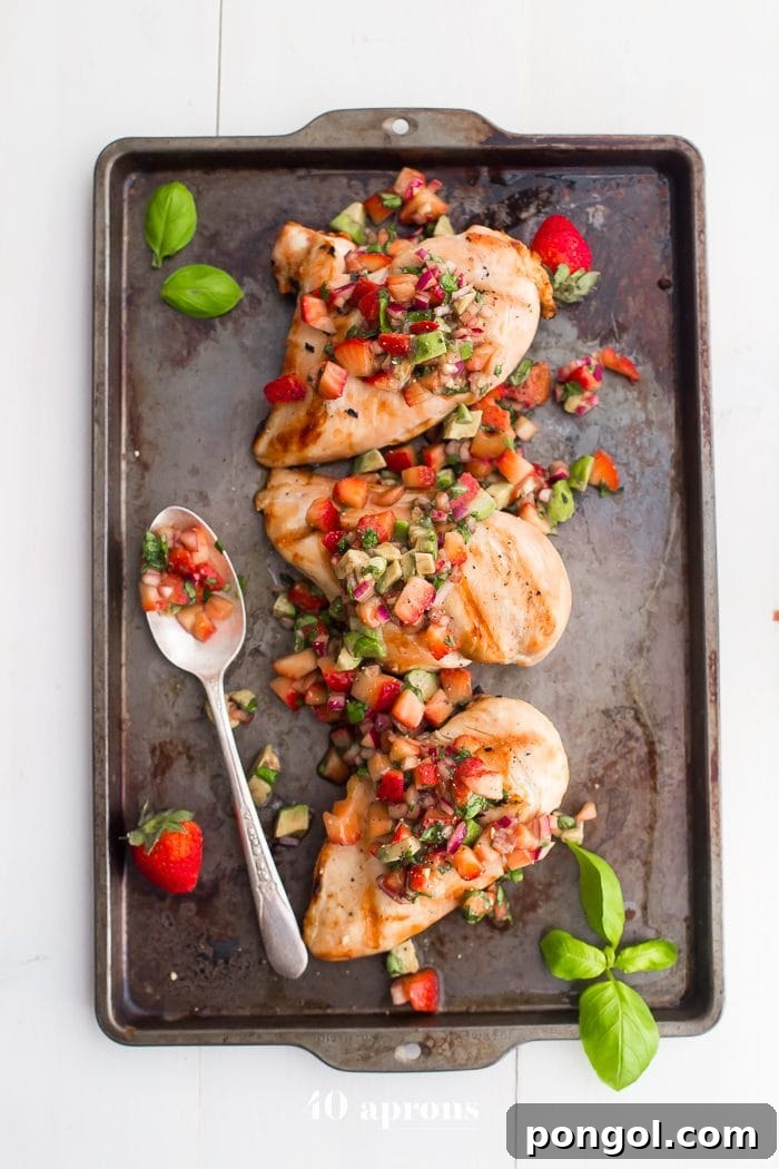 Whole30 Strawberry Basil Chicken plated with fresh avocado slices and a sprinkle of basil