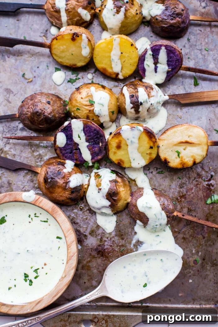 Vibrant grilled red, white, and blue potato skewers with ranch dressing, perfect for patriotic holidays.