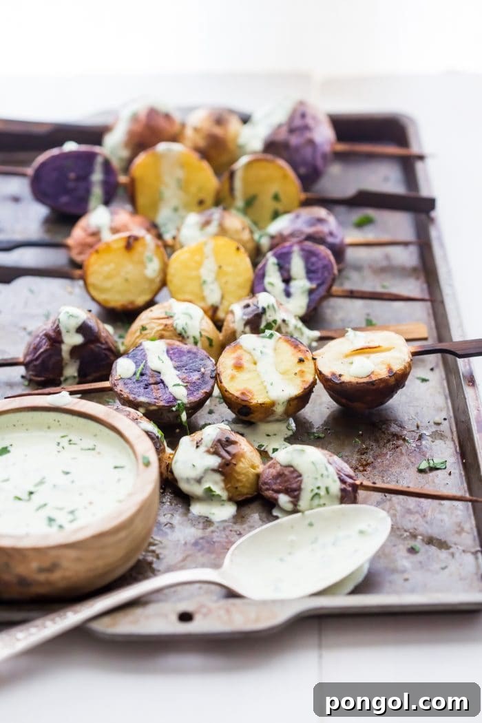 A close-up of a single grilled potato skewer, showcasing the tender interior and golden exterior.
