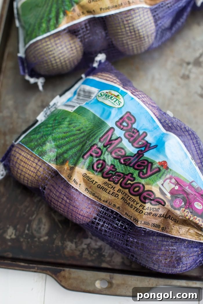 Fresh baby red, white, and blue potatoes, ready for preparation.