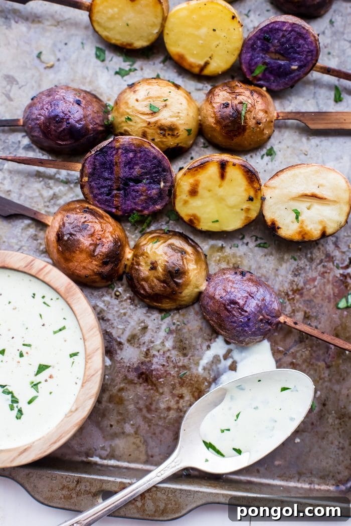 Close-up of a hand adding sliced potatoes to a marinade mixture.