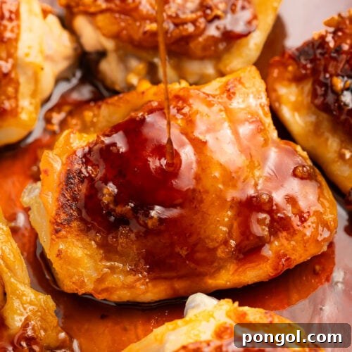 Close-up of a honey garlic chicken thigh in a skillet with honey-garlic sauce.