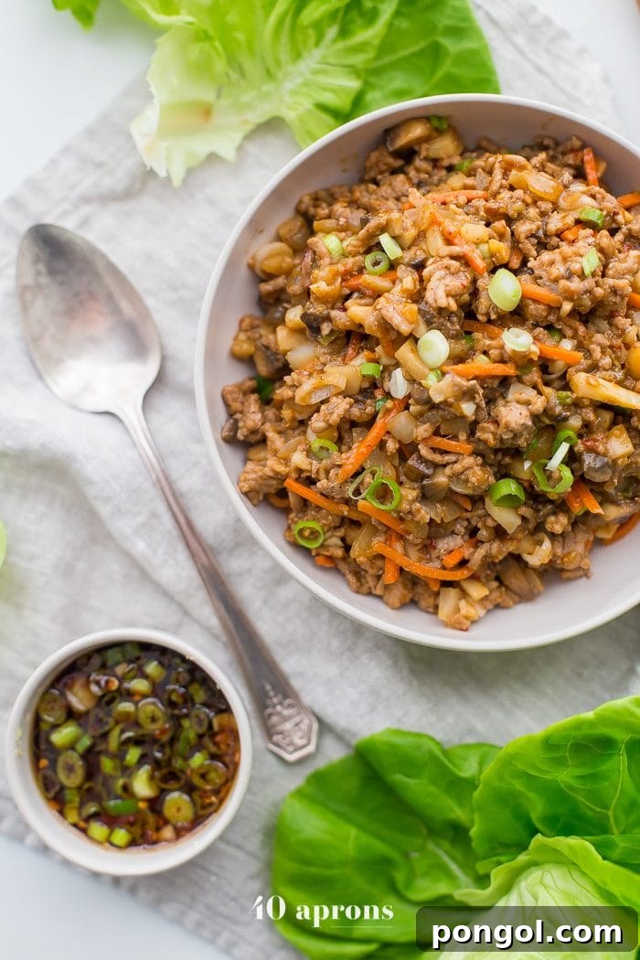 A close-up of a bowl filled with healthy PF Changs style lettuce wrap filling, showcasing the rich texture and vibrant ingredients.