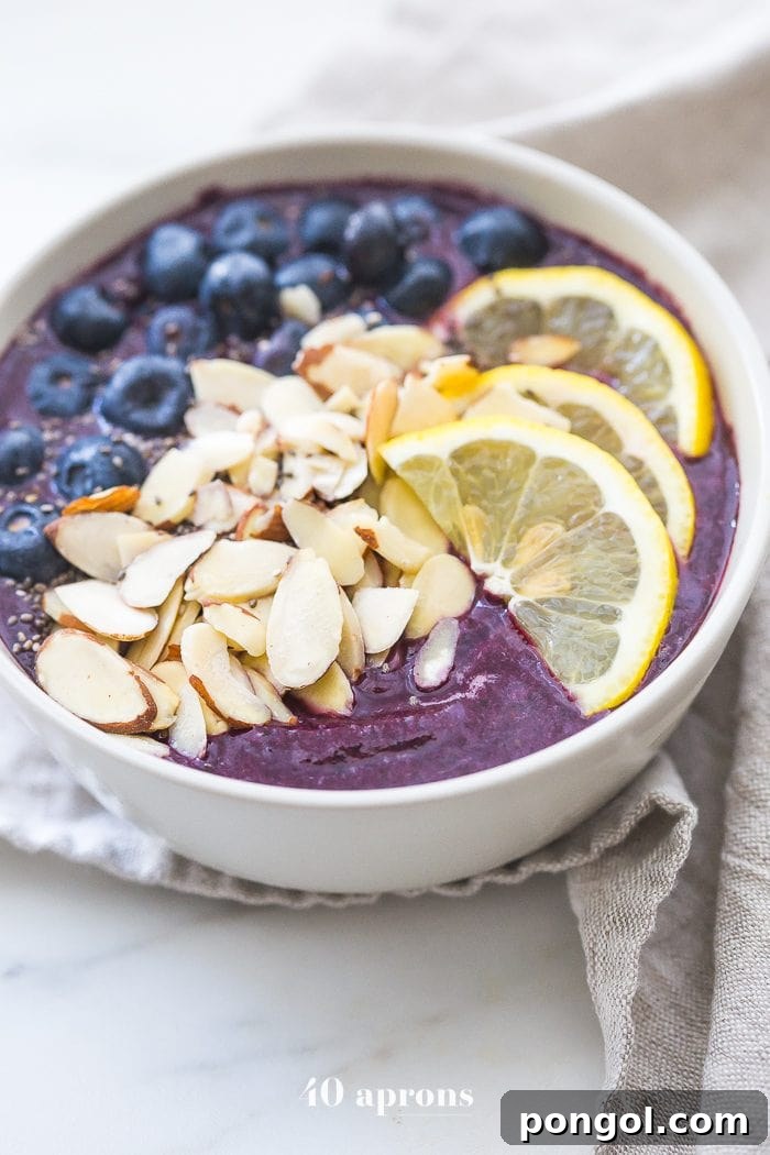 This blueberry muffin smoothie bowl is sweet with a touch of lemon and vanilla, just like a blueberry muffin! This blueberry smoothie bowl takes only 5 minutes and is paleo and vegan. With only 5 ingredients, you'll get addicted to this blueberry muffin smoothie bowl!