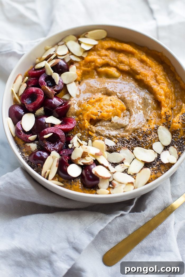 A beautifully presented sweet potato Whole30 breakfast bowl, brimming with a creamy, spiced sweet potato base and artfully arranged toppings like fresh fruit, seeds, and nuts. This image captures the essence of a wholesome, naturally sweet, and nutrient-dense meal, perfect for a Whole30 compliant diet.