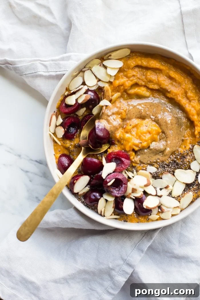 A vibrant and inviting sweet potato Whole30 breakfast bowl, featuring a smooth, spiced sweet potato and banana base, ready to be topped with an array of fresh and dried fruits, nuts, and seeds for a customizable and nutrient-rich Whole30 compliant breakfast experience.