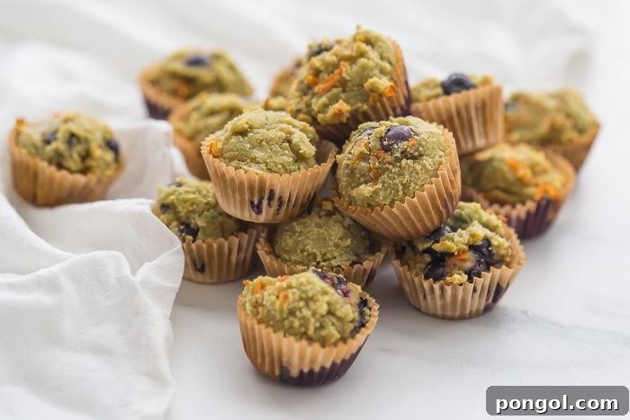 Close-up of fluffy gluten-free muffins featuring visible blueberries and a soft texture, ideal for children with dietary restrictions.