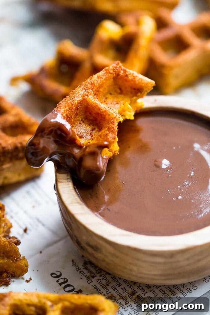 Paleo Pumpkin Churro Waffles with Dark Chocolate Drizzle 5 A plate of freshly made Paleo Pumpkin Churros and a bowl of dark chocolate dipping sauce, ready to enjoy.