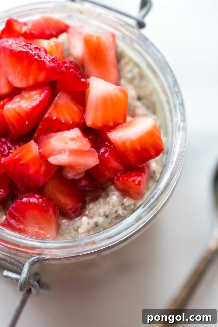 Close-up of the smooth, creamy texture of the chia pudding layer, infused with nut butter, ready to be topped with the macerated strawberry 'jelly' component.