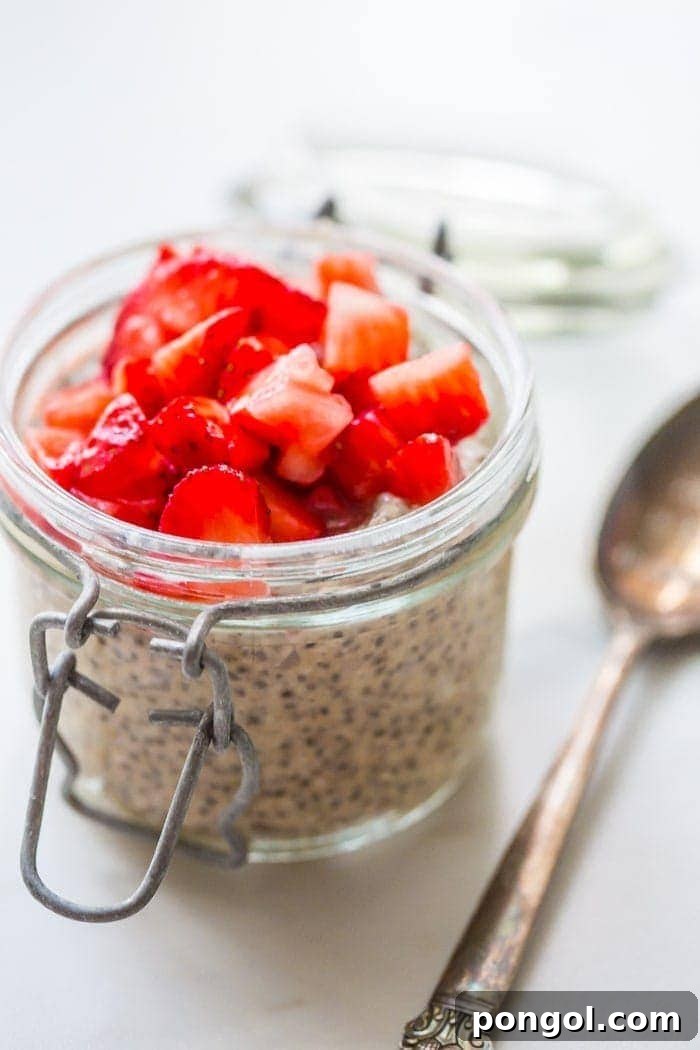A vibrant display of fresh strawberries diced and macerated, showcasing their natural sweetness and readiness to be layered into the PB&J chia pudding.
