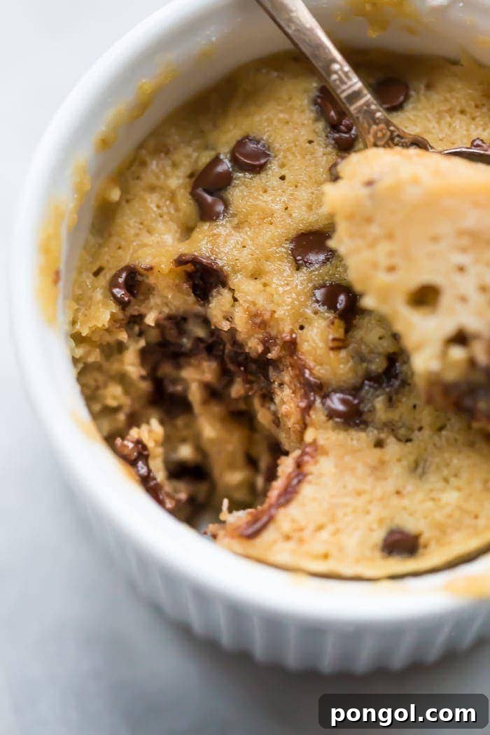 A perfectly baked paleo microwave chocolate chip cookie in a ramekin, ready to be enjoyed as a quick and healthy dessert.