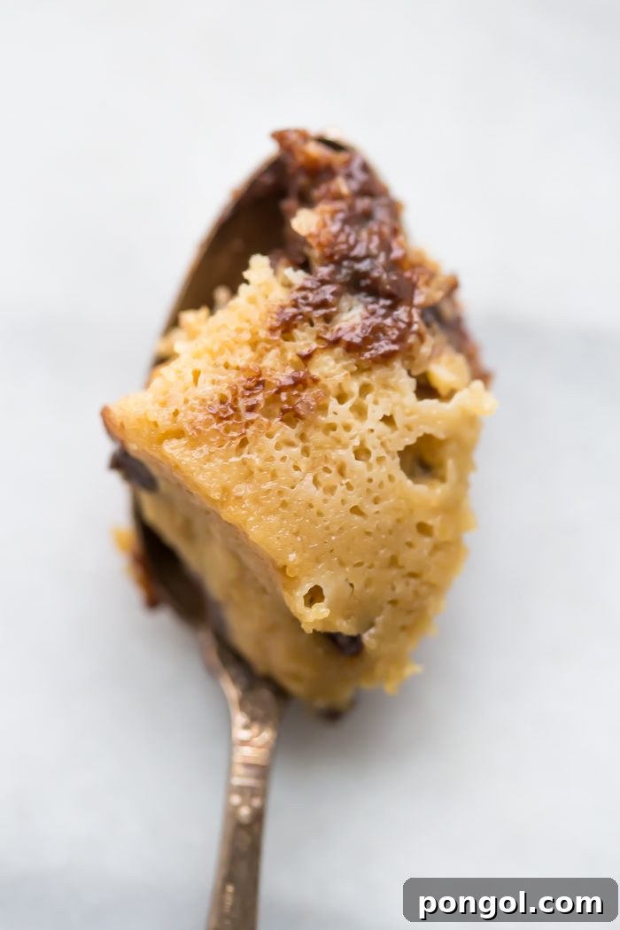 A close-up of the paleo cookie, showing its soft interior and molten chocolate, presented in a simple white ramekin.