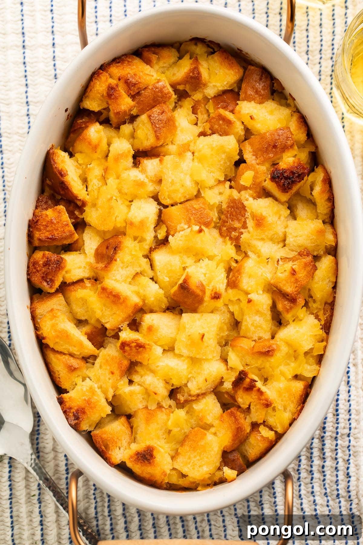 Tropical Pineapple Stuffing 3 An overhead photo of pineapple stuffing in a large white oval ceramic baking dish.