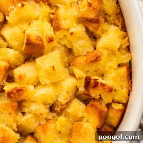 A close-up of pineapple stuffing in a large white oval ceramic baking dish.