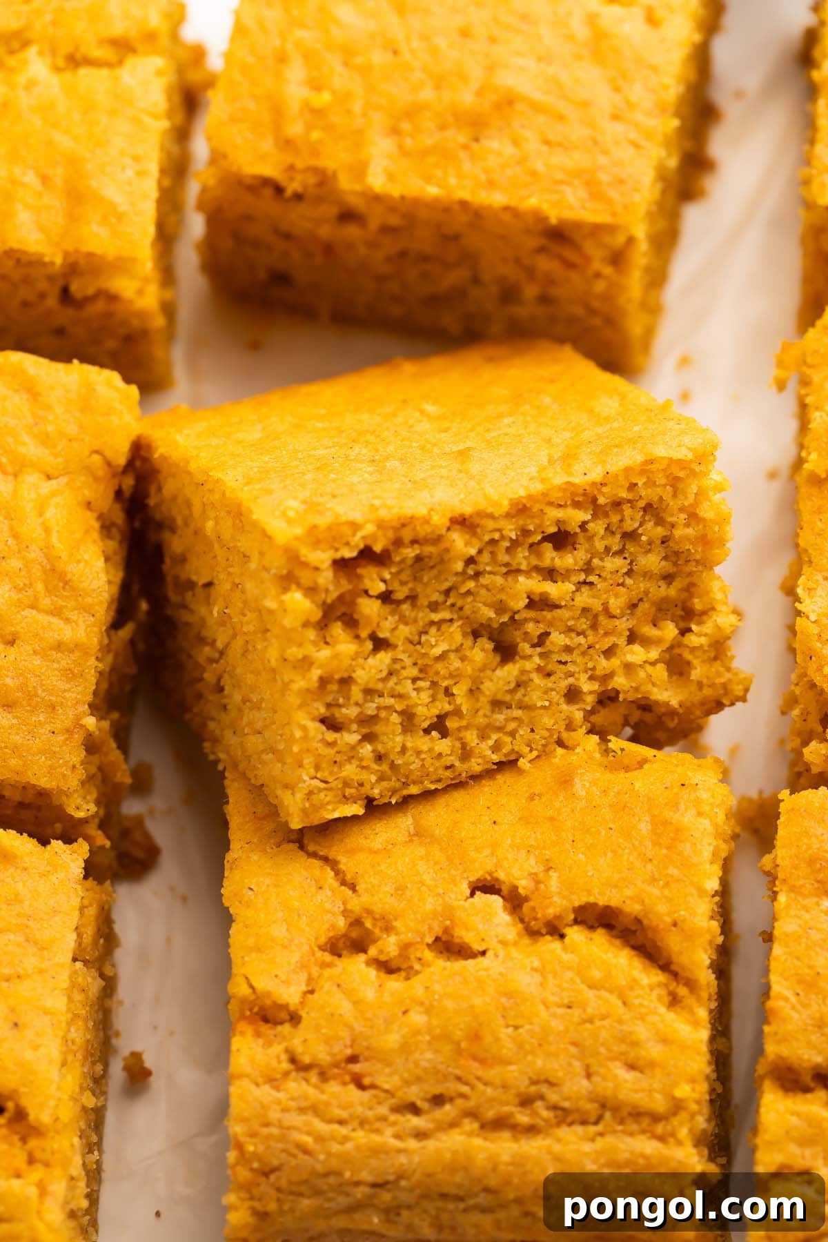 A close-up view of a sweet potato cornbread slice revealing its soft, moist interior and appealing texture.