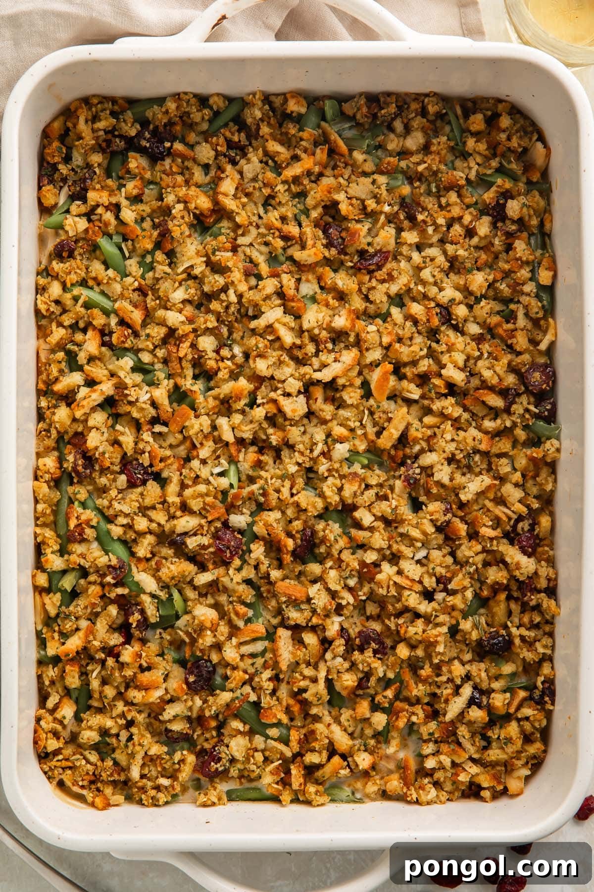Overhead view of a creamy chicken and stuffing casserole in a large white baking dish.