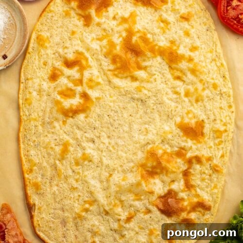 Creamy Cottage Cheese Flatbread Sensation 4 An unfolded cottage cheese flatbread on a sheet of parchment paper surrounded by sandwich ingredients.