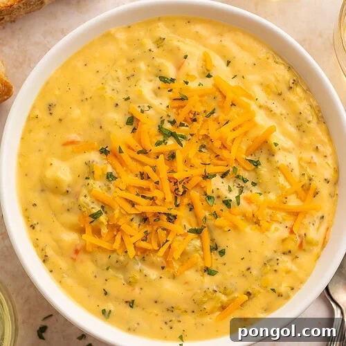 Overhead view of dairy free broccoli cheese soup with bread and wine