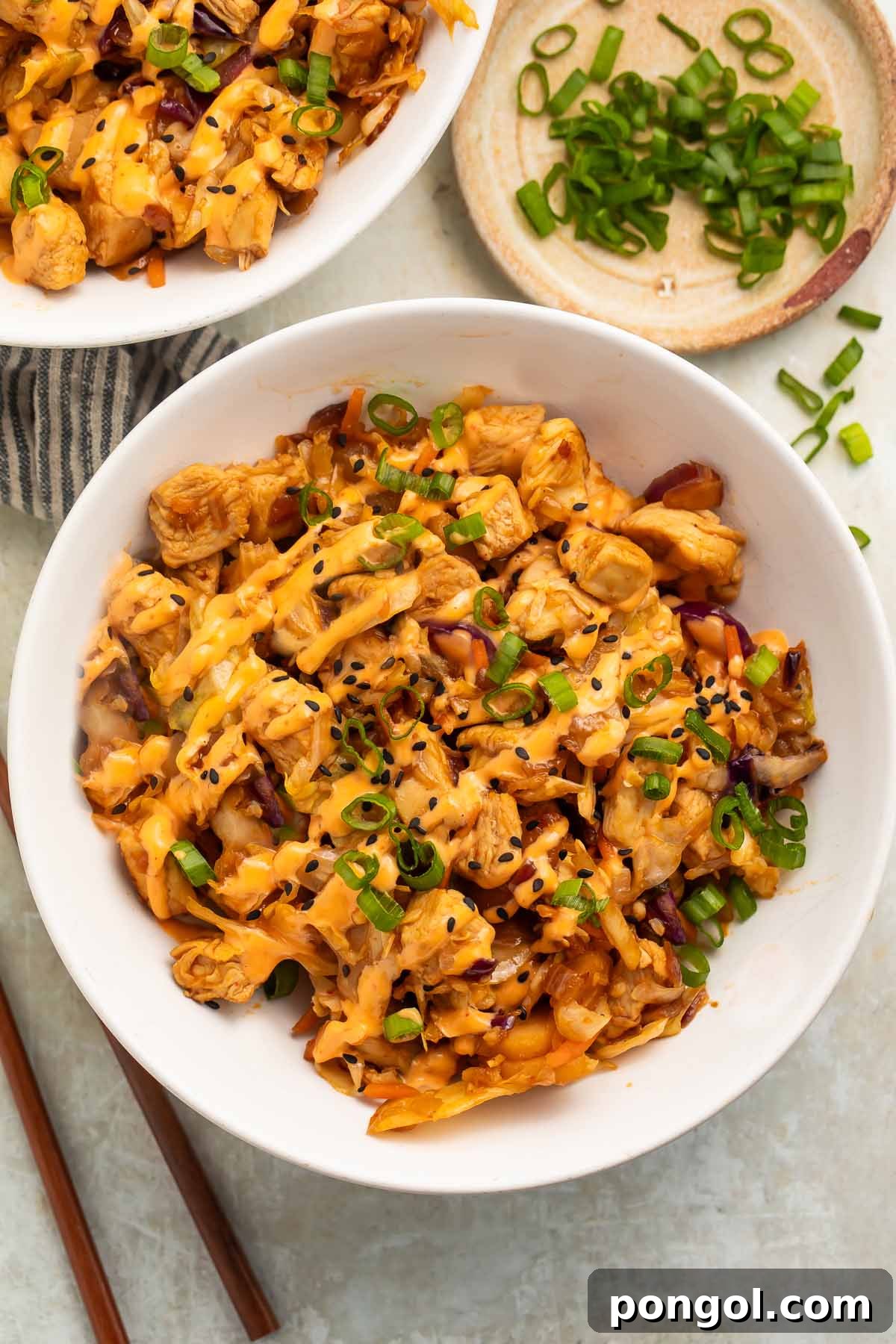 Two bowls of chicken egg roll in a bowl on a table.