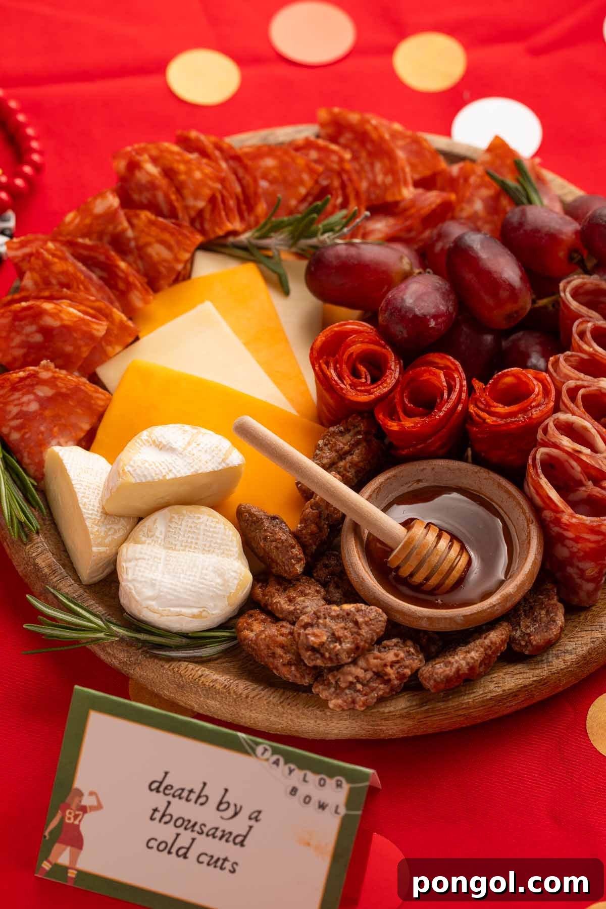 Death by a Thousand Cold Cuts deli charcuterie board, artistically arranged.