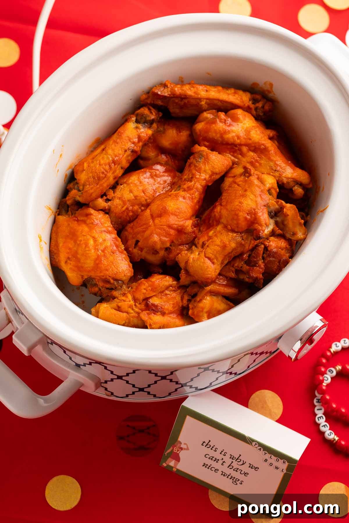 Crockpot chicken wings in a Crockpot on a table, ready to be served.