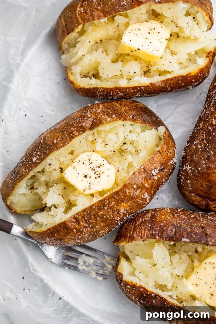 Air fryer baked potato with a fork digging into it.