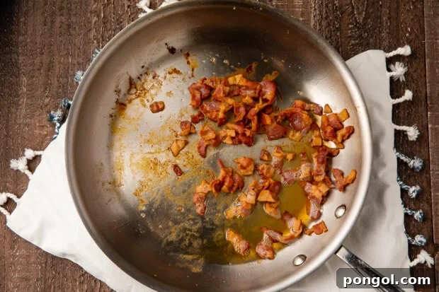 Diced bacon in large silver skillet