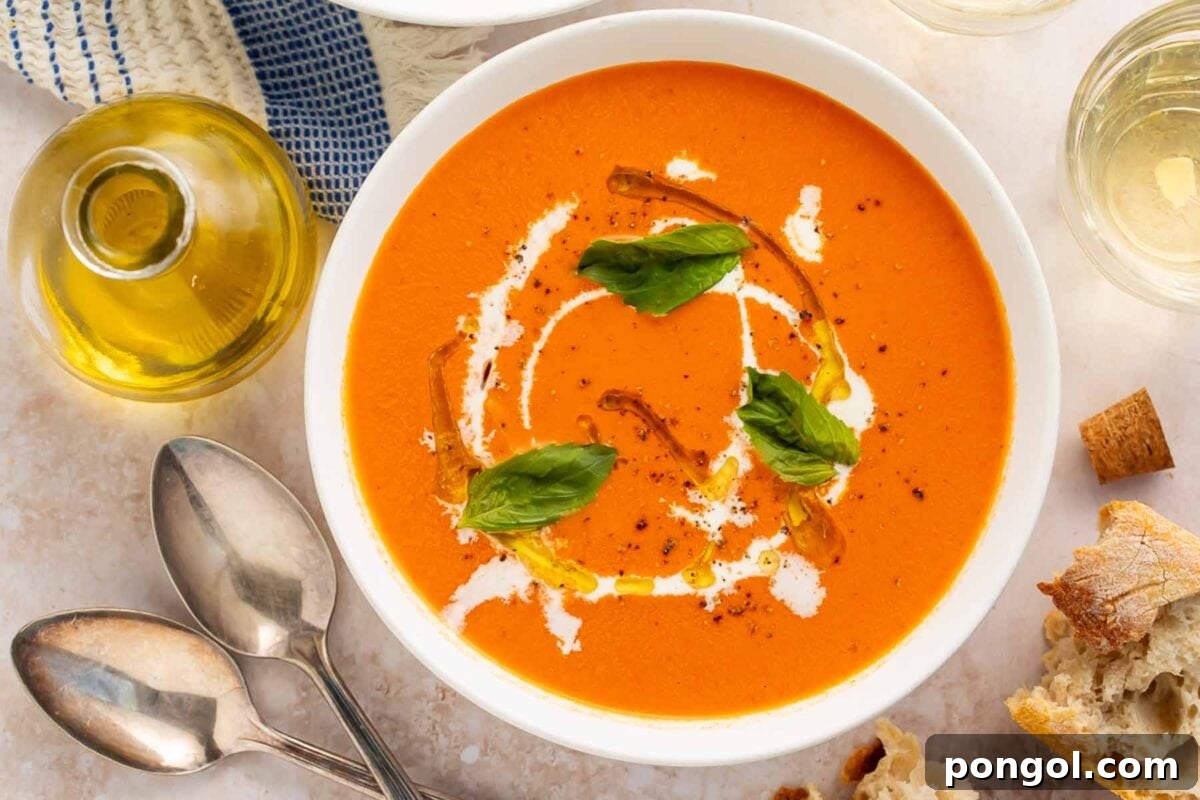 Effortless Instant Pot Tomato Perfection 3 Overhead view of tomato soup in white bowl with basil garnish and bread