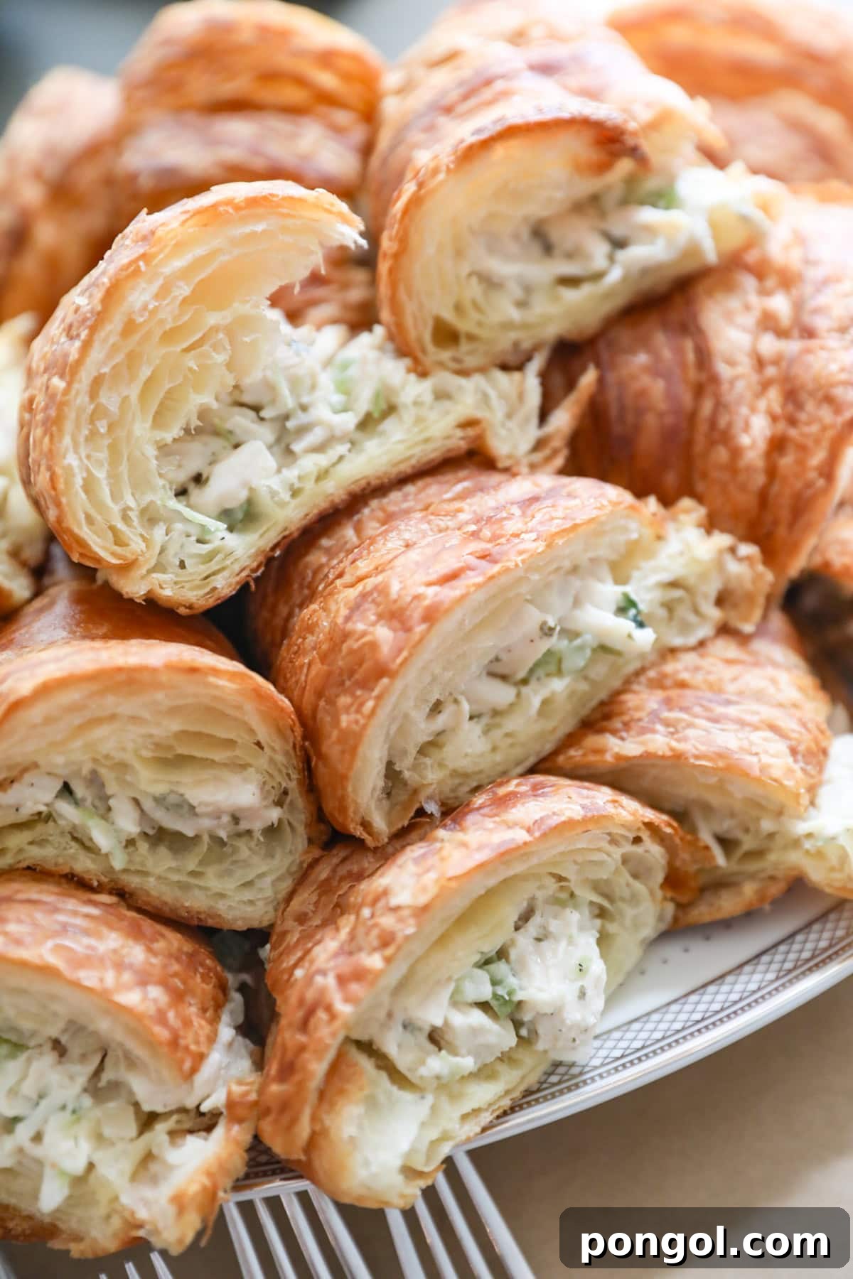 Croissants stuffed with Costco chicken salad, arranged on a platter.
