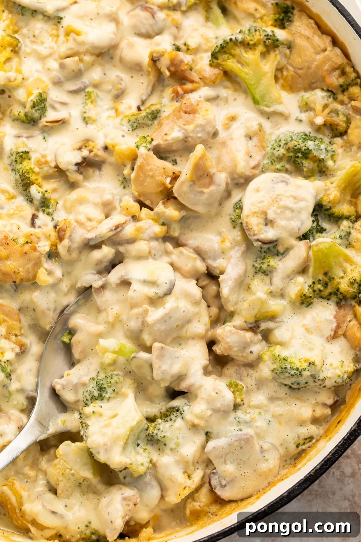 Creamy Whole30 chicken and broccoli casserole in a cast iron skillet, ready to serve.