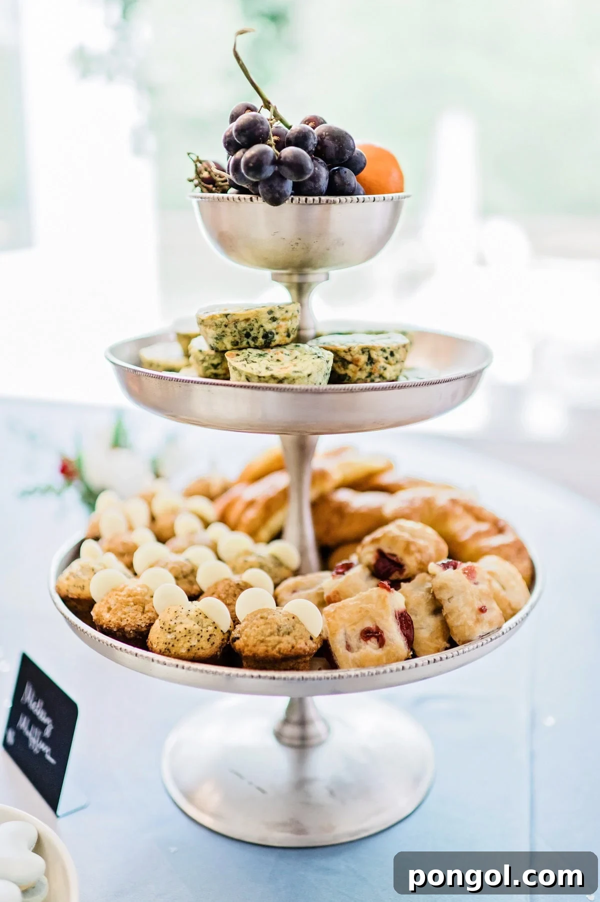 Brunch foods on platters and tiered trays for a Magic Kingdom birthday party.