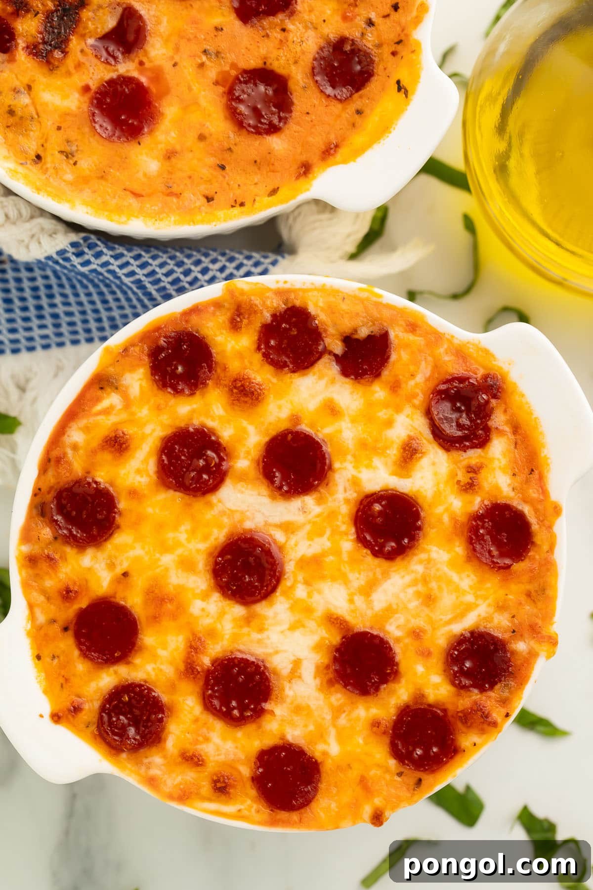 Fit Cottage Cheese Pizza Bowl 2 Two cottage cheese pizza bowls topped with savory pepperoni and garnished with fresh basil, showcasing a quick, high-protein, and low-carb meal option.