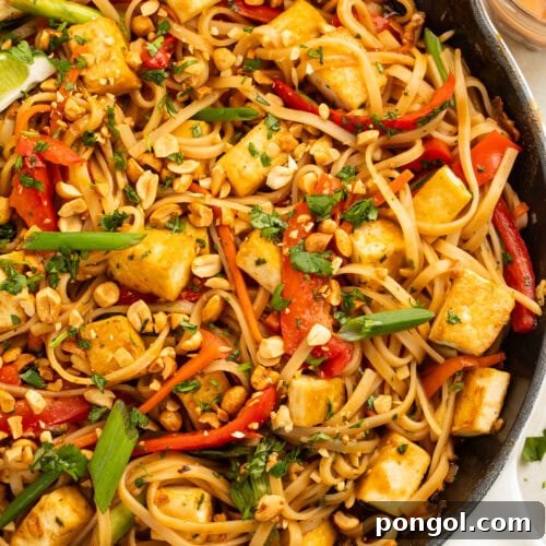 A large skillet of vegan pad thai.