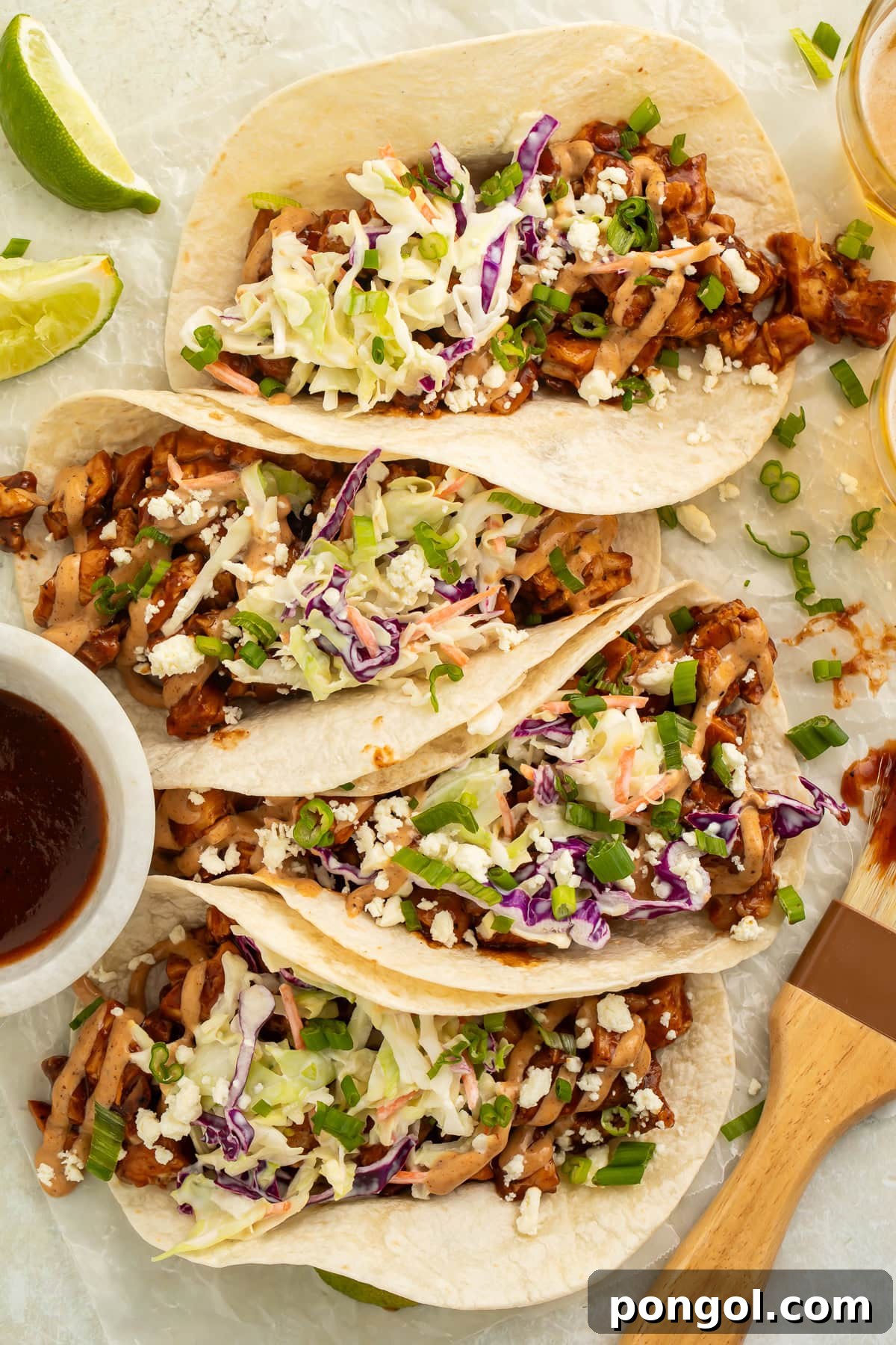 Smoky Chicken Taco Feast 2 Platter of vibrant BBQ chicken tacos, garnished with fresh cilantro and lime wedges, ready to be served.