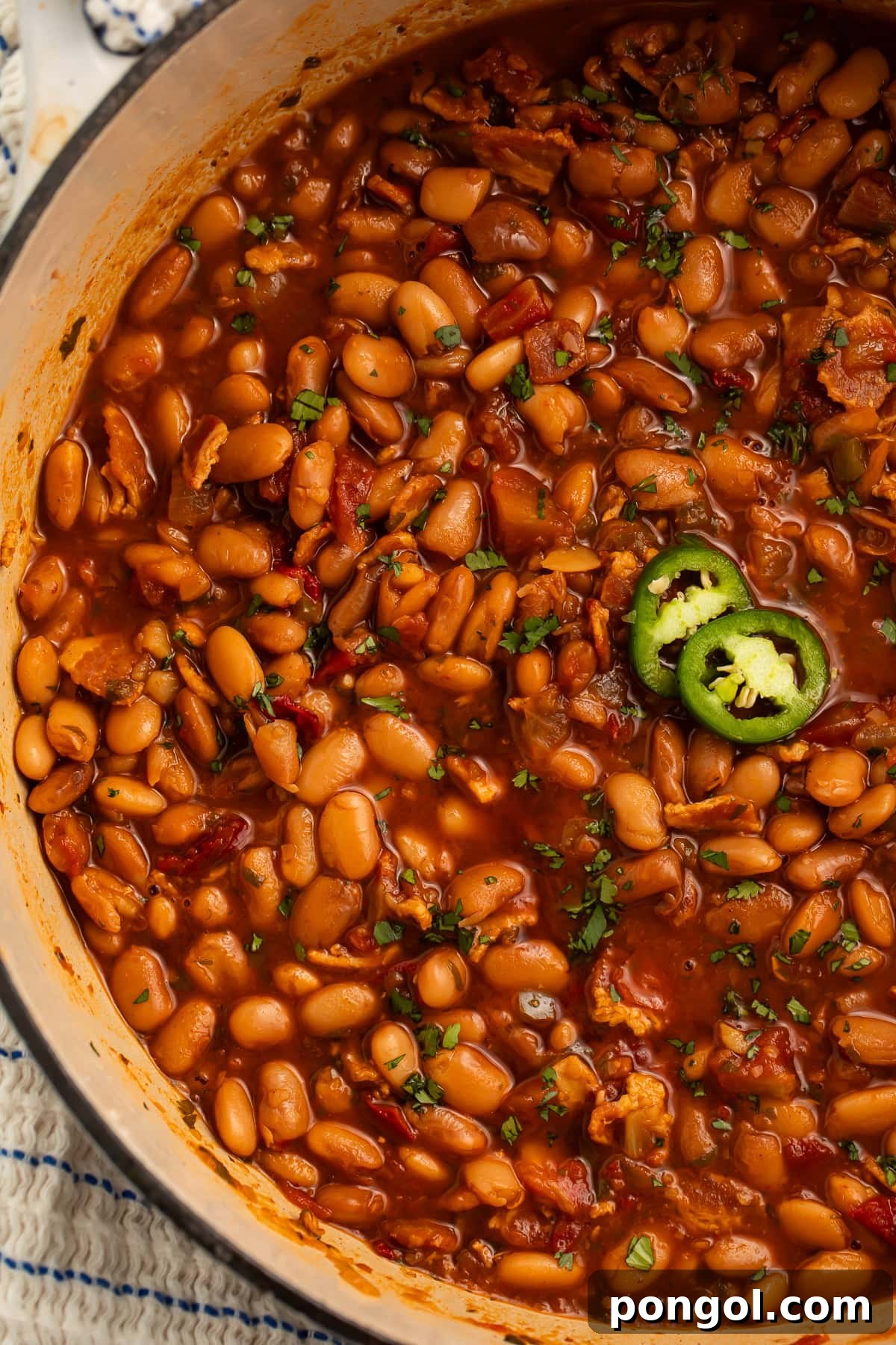 Another view of the charro beans, highlighting the steam rising from the flavorful dish.