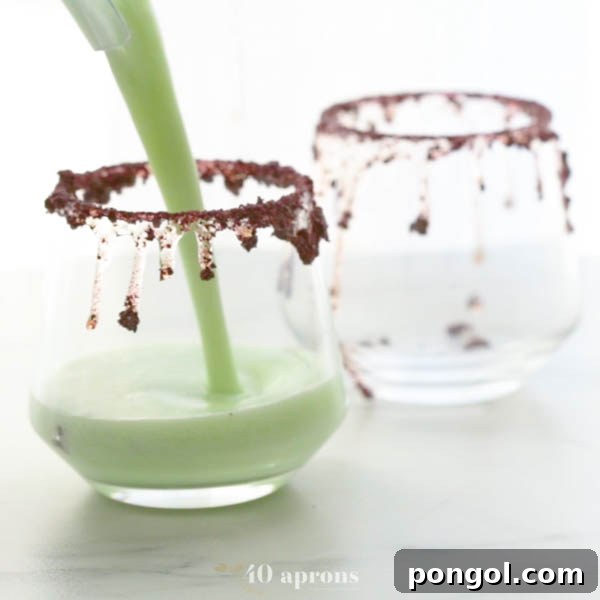 Pour Halloween cocktails into prepared glasses