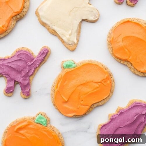 Paleo Halloween cookies with creamy frosting, decorated in festive colors, showcasing a delightful and healthy treat.
