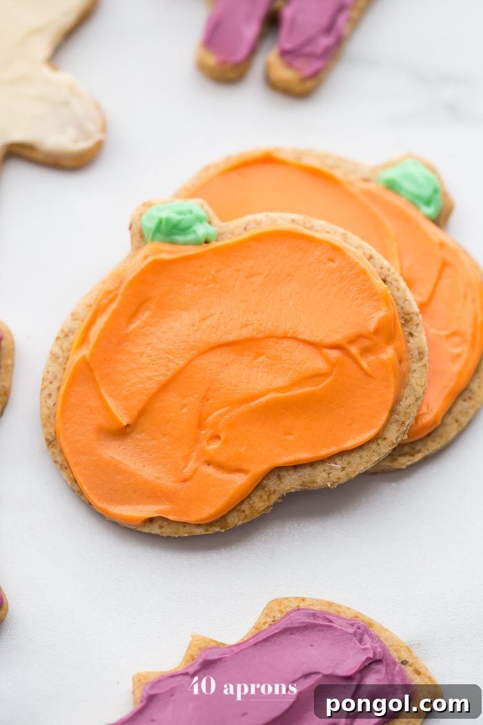 A close-up of a decorated paleo Halloween ghost cookie with white frosting and edible eyes, showcasing its charming detail.