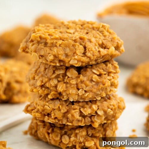 Stack of no bake peanut butter oatmeal cookies on a piece of wax paper.